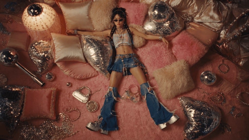 WIZE Fashion — overhead view of a model on pink pillows and denim