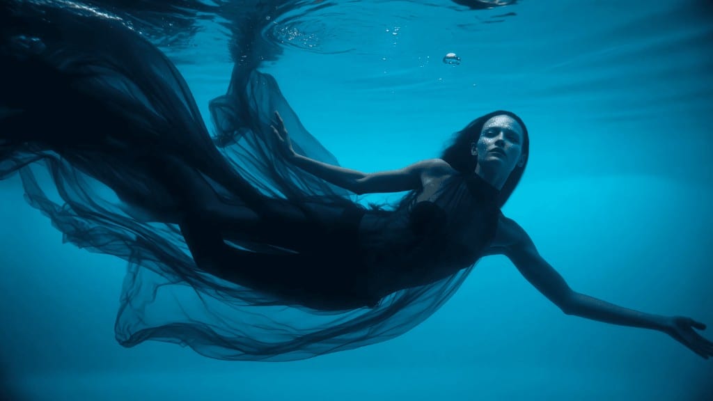 WIZE Fashion — model floating underwater in dark fabric