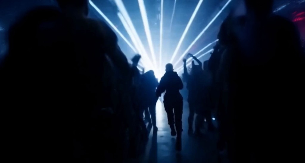 Rave — figure running through a crowd under stage lights