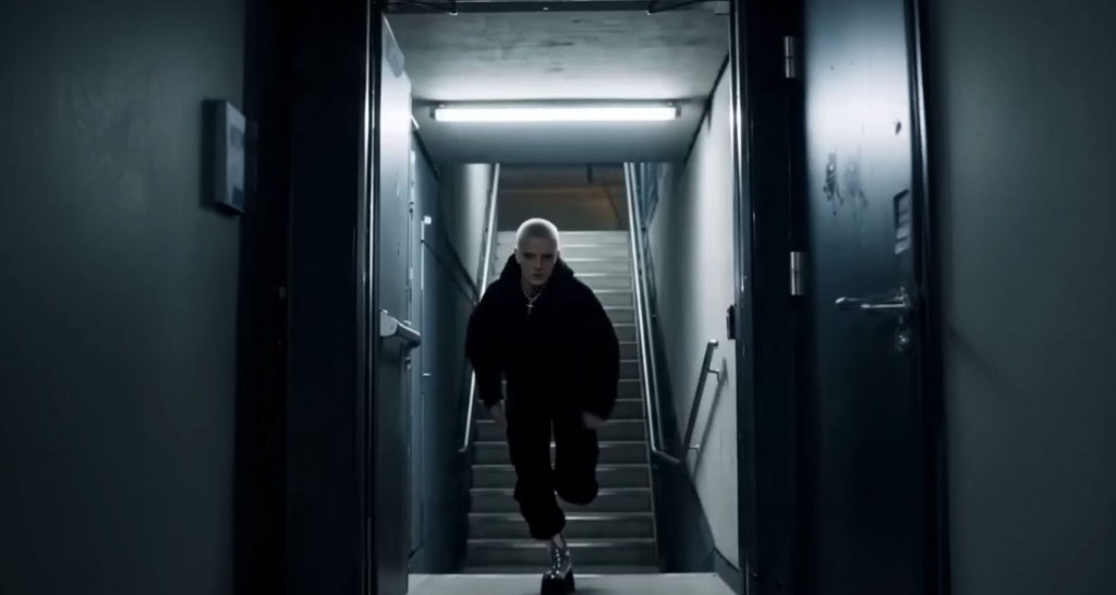 Rave — figure running down a concrete stairwell