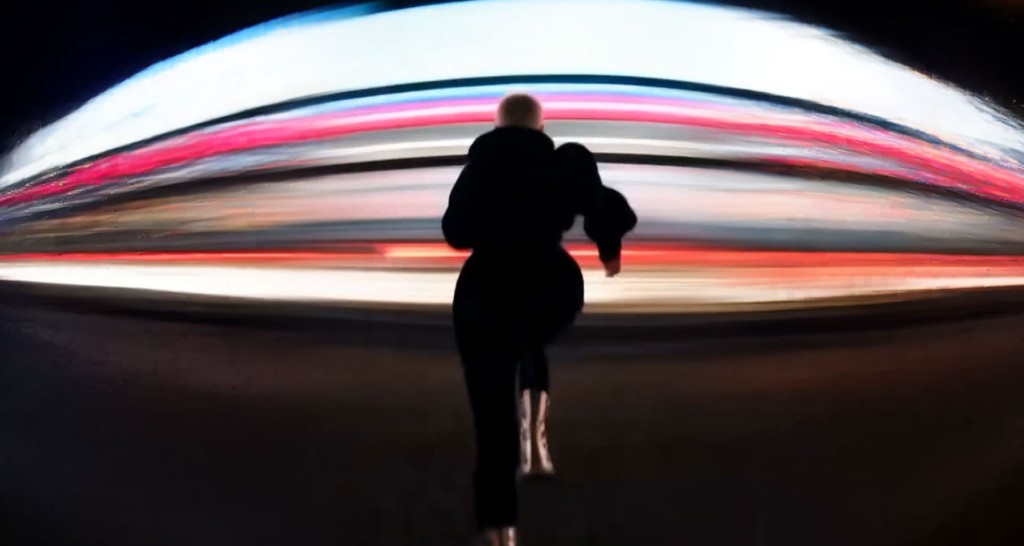 Rave — figure running through streaks of neon light